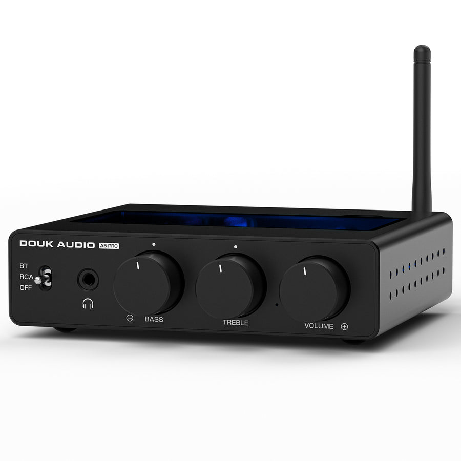 Slim black Bluetooth amplifier labeled DOUK AUDIO A5 PRO on a white background; a tall antenna rises from the right rear, a recessed blue translucent display panel is set into the top, and the front carries a BT/RCA/OFF selector, a headphone jack, and three rotary knobs marked BASS, TREBLE and VOLUME