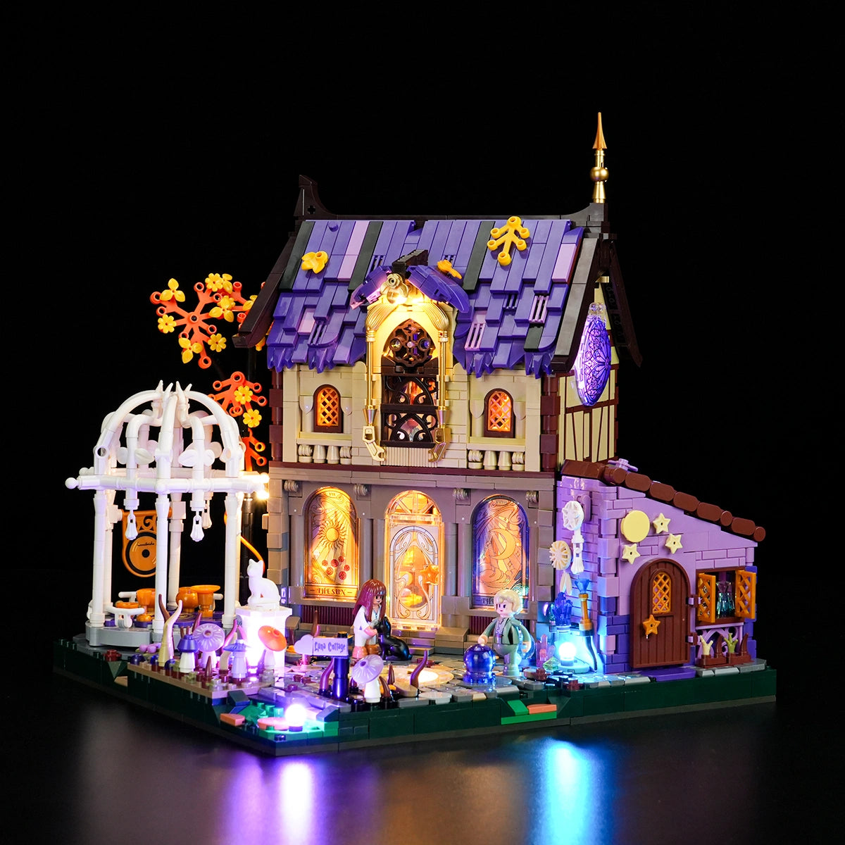 Lumibricks Luna Cottage 10014 brick-built purple-roofed cottage with a white gazebo, glowing windows